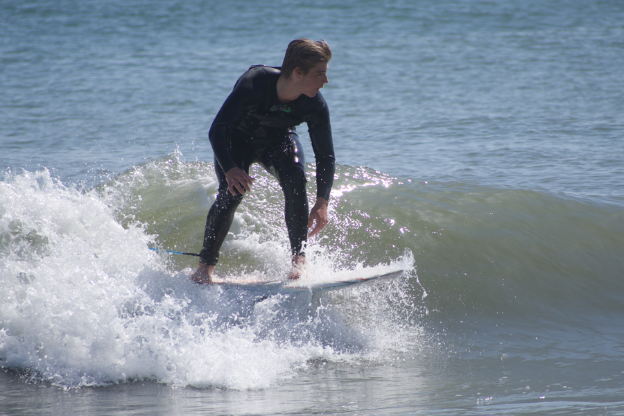A surfer catches a wave on an April day on the Outer Banks. A surfer catches a wave on an April day on the Outer Banks.